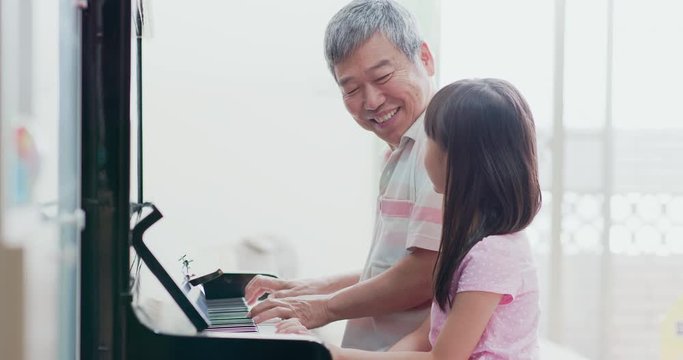 grandpa teach girl play piano