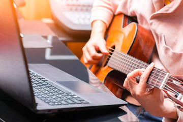 man enjoy learning online guitar lesson from internet