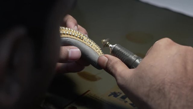 Hand polishing gold jewelry chain jeweler. Production and making manufacturing. 4K