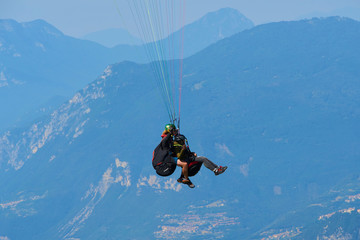 Paraglider flying over the Garda Lake Panorama of the gorgeous Garda lake surrounded by mountains. Paragliding is very popular sport in Monte Baldo. 