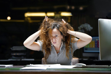 Close-up of office worker is distressed with a lot of paperwork in front of her. Close-up of an...