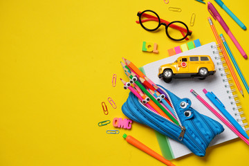 Colorful Back to School concept - office and student supplies on yellow background. Space for text.
