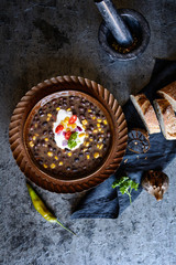 Vegetarian black bean soup with corn, tomatoes and sour cream