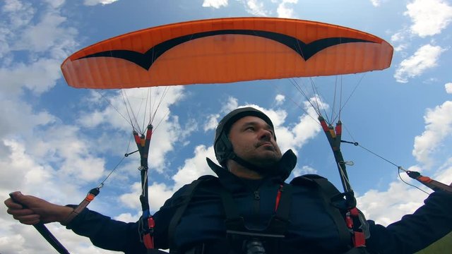 Man is flying the parafoil against the sky