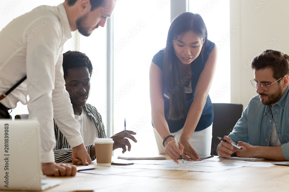 Wall mural focused diverse business team discuss paperwork at group office meeting