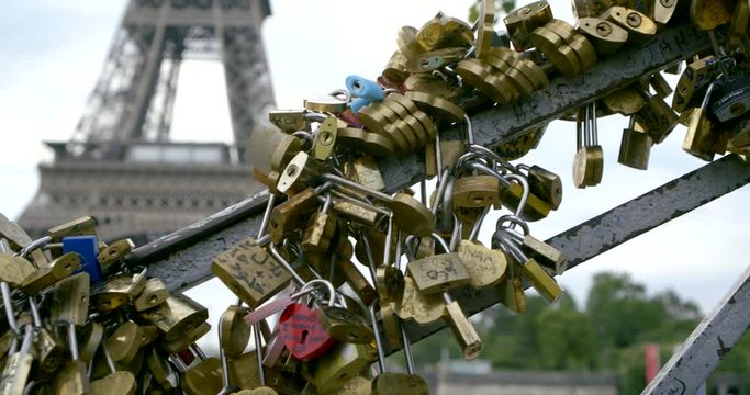 Lovers Bridge with locks against Eiffel Tower slow motion
