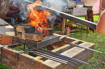 the blacksmith is a master of metal processing.He forges hot metal, and makes products from it.