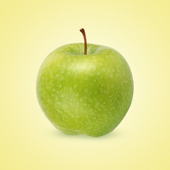  green apple on a yellow background.