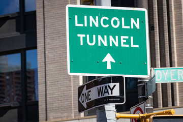 Directional street sign: "LINCOLN TUNNEL" directing traffic to exit Manhattan
