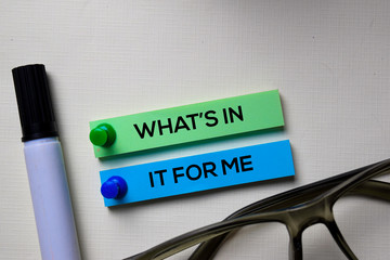 What's In It For Me text on sticky notes isolated on office desk