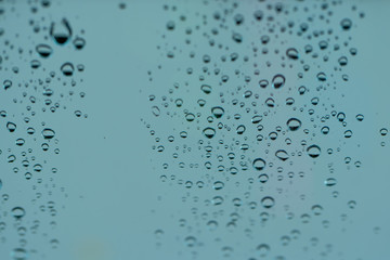 Morning dew droplets condensed on the surface of a window