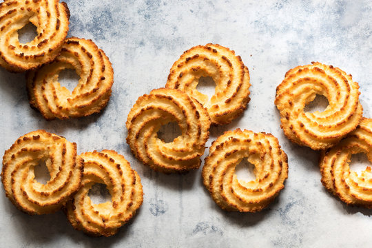 Coconut biscuits scattered on a blue background.