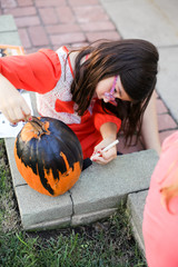 A family is decorating pumpkins during Halloween.