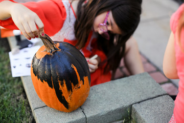 A family is decorating pumpkins during Halloween.