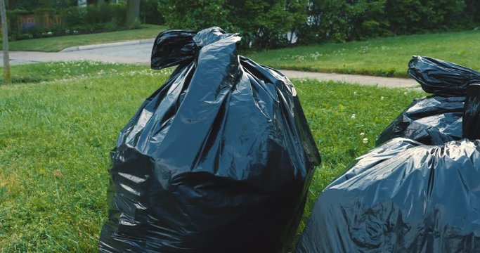 Black, plastic garbage bags put out for collection