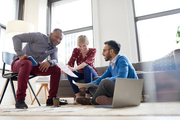 Multi-ethnic team of creative millenials collaborating on a brainstorm project