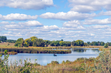 Obraz premium Beautiful summer landscape with a river and blue sky.