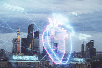 Multi exposure of human heart hologram on Moscow cityscape background. Concept of medical education