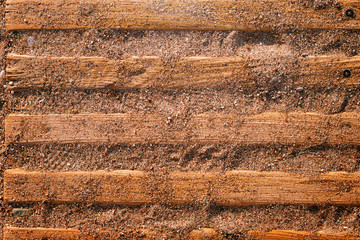 Beach wooden path covered with sand
