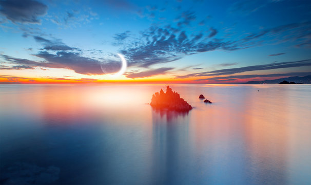 Long exposure of sunset at Alanya Beach, Alanya, Antalya - Long exposure image of Dramatic sky and seascape with rock and crescent moon
