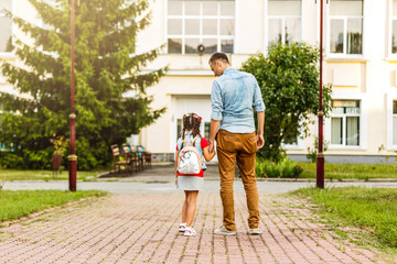 Child going back to school. Start of new school year after summer vacation. Little girl with backpack and books on first school day. Beginning of class. Education for kindergarten and preschool kids.