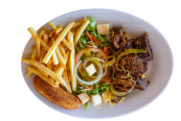 Brazilian northeastern traditional dish, Sol Carne with chips, salad, and fried banana