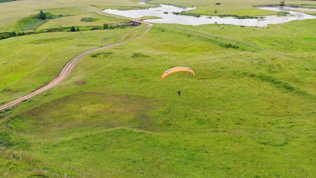 Paragliding process in a view from above. Extreme sport concept.
