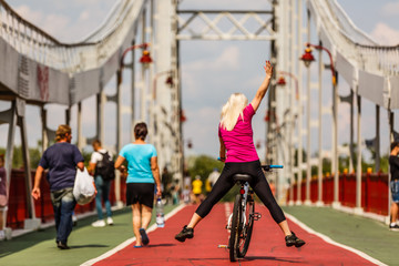 Obraz premium Woman riding bicycle with her legs in the air