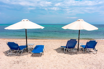 Umbrellas and sunbeds on Platania beach, Sithonia, Chalkidiki, Greece