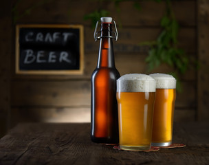 Beer. Beer bottle and glass on a wooden background