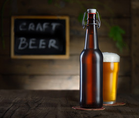 Beer. Beer bottle and glass on a wooden background