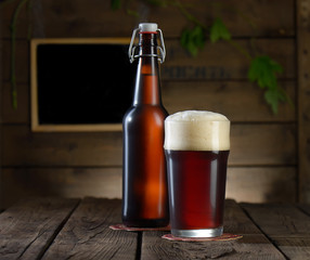 Beer. Beer bottle and glass on a wooden background