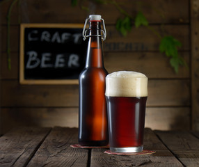 Beer. Beer bottle and glass on a wooden background
