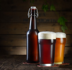 Beer. Beer bottle and glass on a wooden background