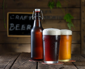 Beer. Beer bottle and glass on a wooden background