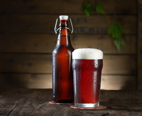 Beer. Beer bottle and glass on a wooden background