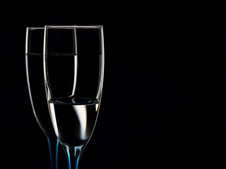 Elegant picture of glasses with clear water on a black background