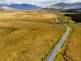 Beautiful sunset view of Connemara region in Ireland. Scenic Irish countryside landscape with magnificent mountains on the horizon, County Galway, Ireland.