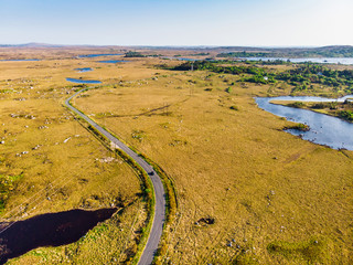 Beautiful sunset view of Connemara region in Ireland. Scenic Irish countryside landscape with magnificent mountains on the horizon, County Galway, Ireland.