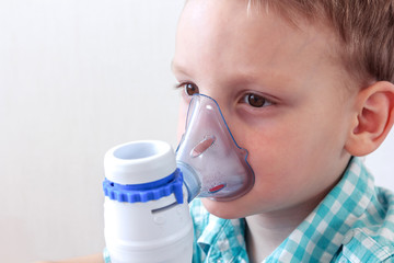 Kid having asthma allergy using the asthma inhaler for being healthy