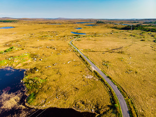 Beautiful sunset view of Connemara region in Ireland. Scenic Irish countryside landscape with magnificent mountains on the horizon, County Galway, Ireland.