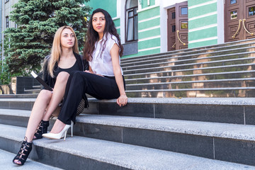 Portrait of two beautiful women on stairs