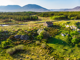 Beautiful sunset view of Connemara region in Ireland. Scenic Irish countryside landscape with magnificent mountains on the horizon, County Galway, Ireland.