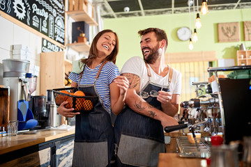Man and woman barista owner working at coffee shop.