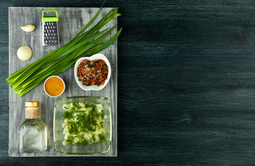 Zucchini in the background. Fried young sliced courgettes in a pan on a dark background. The view from the top. Copy space