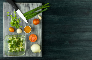 Zucchini in the background. Fried young sliced courgettes in a pan on a dark background. The view from the top. Copy space
