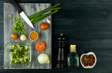 Zucchini in the background. Fried young sliced courgettes in a pan on a dark background. The view from the top. Copy space