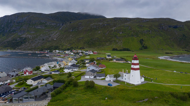 Alnes Lighthouse, old and famous building, established in 1852 to guide fishing boats to the harbor of the fishing community of Alnes, More og Romsdal county, Norway. Aerial(drone) view in jule, 2019