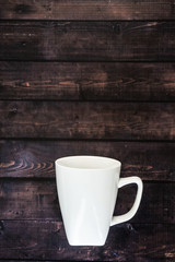 Single coffee mug on a wooden table background - java espresso with copy space