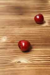 Red sweet cherry scattered on a wooden table